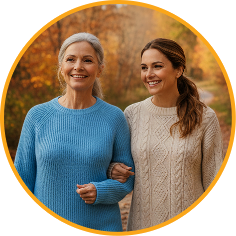 Older woman and her adult daughter walking together outdoors, smiling